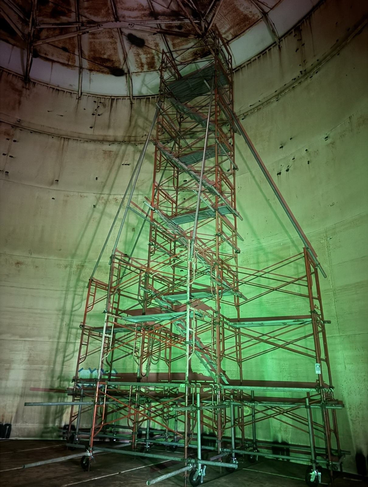 Tall scaffold tower erected inside a steel tank