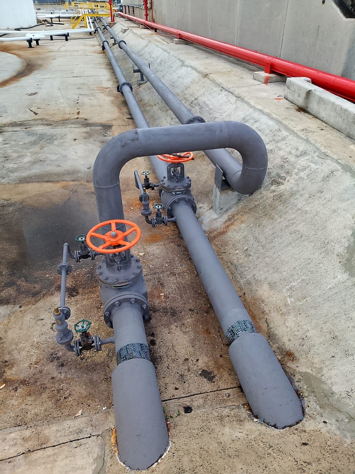 New grey 8-inch fuel pipeline with red valve wheel